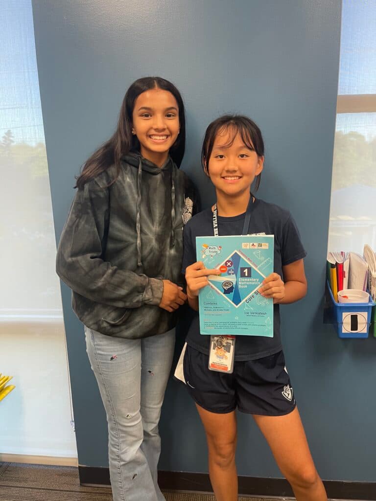 Students holding the Core Skills book